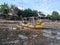 The fishing boats are stopping at the beach where the sea water is receding