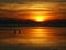 Fishing at dawn under an incredible orange sunrise, Bali.