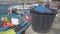 Fishing equipment lying on pier in resort town, wooden boat floating on water