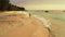 Fishing handsome man relaxes and spends quality time at beach on summer white sandy and blue 4K background