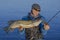 Fishing. Happy fisherman with big pike fish