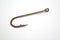 Fishing hook on a white paper background