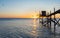 A fishing hut called carrelet with craft lifting net at sunset. Esnandes, charente maritime, France. The sun is caught in the net