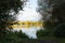 Fishing lake and pylons seen through trees