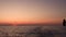 Fishing line, high rock and Lipari Island in Mediterranean sea against horizon. Colorful sky, summer sunrise or sunset
