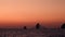 Fishing line, high rocks and Lipari Islands. Sailing boat in Mediterranean sea against horizon. Colorful sky, sunrise or