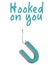 A fishing line and hook is hooked to the letter U