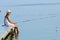 Fishing - lovely girl fishing on the pier