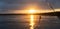 Fishing lure on line above the Naknek River in Alaska during sunrise