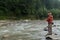 Fishing on mountain river in summer