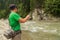 Fishing on mountain river in summer