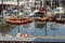 Fishing net with bouys hang in front of harbor town