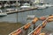 Fishing net with bouys hang in front of harbor town