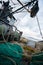 Fishing nets are on the deck of a small fishing vessel