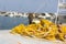 Fishing nets and Greek fishing boats mooring in port in sunrise