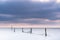 Fishing nets in a large lake during twilight with sunset colored sky clouds