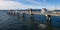 Fishing Pier at Edmonds Washington with a car ferry passing under blue sky