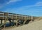 Fishing pier meets sand dune