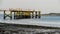 Fishing pier with peoples enjoying nice evening on Calf Pasture Beach