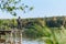 Fishing for pike, perch, carp. Fisherman with rod, spinning reel on river bank. Man catching fish, pulling rod while fishing on