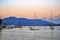 Fishing and pleasure boats at anchor in a picturesque sea bay at sunset