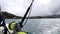 Fishing pole rod and reel on back of boat with ocean wake