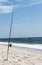 Fishing pole standing upright in holder in the sand on Fire Island New York