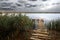 Fishing pond under stormy clouds