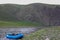 A fishing raft and kayak anchor on grass bank beside the river