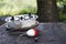 Fishing reel with fishing line, red and white float, hook and sinker on wooden table on natural background