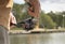 Fishing with reel rod over water river in summer. Closeup of maile hands