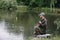 Fishing in river.A fisherman with a fishing rod on the river bank. Man fisherman catches a fish pike.Fishing, spinning