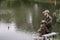 Fishing in river.A fisherman with a fishing rod on the river bank. Man fisherman catches a fish pike.Fishing, spinning