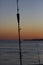 Fishing rod with blurred scene of sunset