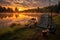 fishing rod and camping gear on a lakeside campsite at dawn