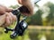 Fishing rod closeup in hands of fisherman