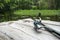 Fishing rod lies on the wooden weathered pier by the river