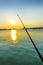Fishing rod in ocean at dawn