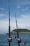 Fishing rods on a boat over blue sea, sky and green island