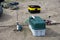 Fishing on the sandy beach. fishing rods and a box with baubles and other fishing accessories on the river Bank. Focus on the blue