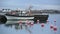 Fishing schooner and Bright plastic buoys in lead-gray water of the Baltic Sea.