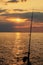 Fishing by the sea in the idyllic evening light of the sun