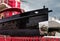 fishing ship and sailboat under repair in a shipyard light reflection on metal on a sunny winter day