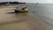 Fishing ship on sand coast near water. Old deserted rusty fishing boat on sand shore near sea in sunny day, koh Samui