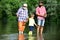Fishing. Summer weekend. Father and son fishing. Fishing in river. Three generations ages: grandfather, father and young