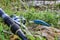 Fishing tackle on coast of the river lying in the grass