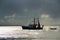 Fishing trawler boat in harbour stormy sunset