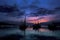 fishing trawlers silhouette framed by moonlit clouds at dusk