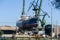 Fishing vessel Grateful on dry dock at Stocznia Gdanska Shipyard, view of the prefabrication workshop and heavy cranes