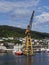 Fishing Vessels moored beside a large Yellow Shore Crane at the Fishing Port in Bergen,